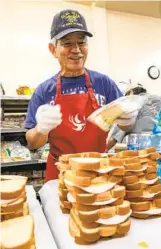  ?? DON BOOMER ?? Michael Fontes of Escondido makes sandwiches and partially funds the cost with his wife, Jane.