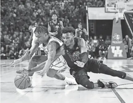  ?? MARIA LYSAKER/USA TODAY SPORTS ?? Houston guard Marcus Sasser, left, and Memphis guard Keonte Kennedy scramble for a loose ball during the first half at Fertitta Center.