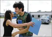  ?? THE SAN ANTONIO EXPRESS-NEWS ?? U.S. citizen Francisco Galicia, 18, gets a hug from attorney Claudia Galan after his release from a detention facility Tuesday.