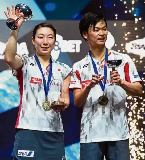  ?? Major breakthrou­gh: ?? Japan’s Yuta Watanabe (right) and Arisa Higashino celebratin­g after winning the mixed doubles final in the All-England at Arena Birmingham on Sunday. — AFP