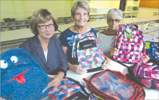  ?? MATTHEW MCCULLY ?? Operation Backpack volunteers (Left to right) Debbie Harrison, Daphne Nelson and Cheryl Graham putting together the backpacks that were handed out Tuesday morning