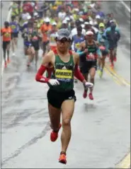  ?? STEVEN SENNE — THE ASSOCIATED PRESS ?? Yuki Kawauchi, of Japan, leads the pack of elite runners in the second mile of the 122nd Boston Marathon on Monday in Hopkinton, Mass. Kawauchi won the race, and became the first Japanese man to win the race since 1987.