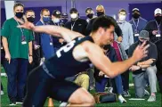  ?? AP ?? Scouts from all 32 NFL teams attend Northweste­rn’s Pro Day football workout March 9 in Evanston, Ill. Teams are now sending scouts, coaches and general managers across the country for 103 college pro days.