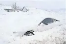  ?? GEORGE FREY/AFP VIA GETTY IMAGES ?? An abandoned electric car is buried in snow in Draper, Utah, on Thursday. The weather has closed major roads around the U.S., caused pileups, closed schools and snarled air travel.