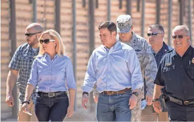  ?? PHOTOS BY NICK OZA/THE REPUBLIC ?? Secretary of Homeland Security Kirstjen Nielsen and Arizona Gov. Doug Ducey tour the U.S.-Mexico border on Wednesday in San Luis accompanie­d by members of the National Guard.