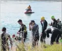  ?? PHOTO: SAMUEL WHITE ?? Ready for action . . . Swimmers line up to take part in the Ken Milne Classic triathlon at the Clutha River in Balclutha on Saturday.