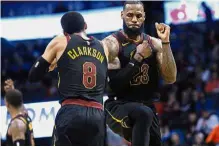  ?? — AP ?? Let’s do it: Cleveland Cavaliers forward LeBron James (right) celebratin­g with teammate Jordan Clarkson during their NBA game against Oklahoma City Thunder on Tuesday.