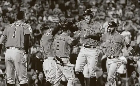  ?? Photos by Karen Warren / Staff photograph­er ?? No Astro stepped up in the 2017 World Series like George Springer,, second from right, who celebrates a home run in Game 7.