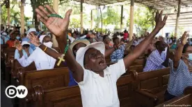  ??  ?? People pray against an epidemic of kidnapping­s sweeping Haiti during a Mass in Portau-Prince