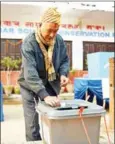  ?? MATHEMA/AFP PRAKASH ?? A Nepali voter casts his ballot at a polling station during the second round of general elections in Kathmandu yesterday.