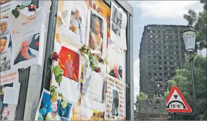  ?? AP PHOTO ?? Pictures of missing people on a message board near to the burnt Grenfell Tower apartment building standing testament to the recent fire in London Friday.