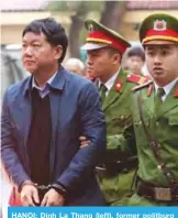  ??  ?? HANOI: Dinh La Thang (left), former politburo member and former Vietnam’s National Oil Company PVN (PetroVietn­am), is escorted by policemen to the courtroom at Hanoi People’s Courthouse yesterday. —AFP