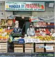  ?? Foto: dpa ?? Obstverkäu­fer mit Mundschutz auf einem Markt in Italien.