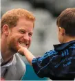 ??  ?? Dylan Mahon (4) touches Prince Harry’s beard