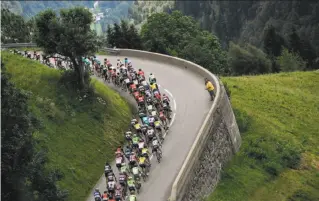  ?? Jeff Pachoud / AFP / Getty Images 2016 ?? The pack rides between Megeve and Morzine-Avoriazin in the French Alps during the 20th stage of the 2016 Tour de France, which was won by British rider Chris Froome.