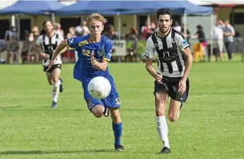  ?? Photo: Nev Madsen ?? CUP CLASH: USQ’s Cormac McCarthy (left) and Willowburn’s Callum Hart battle for control of the ball. The two sides play today in the FFA Cup.