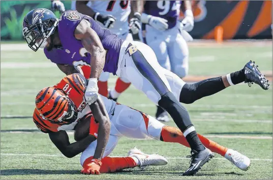  ?? [FRANK VICTORES/THE ASSOCIATED PRESS] ?? Ravens cornerback Jimmy Smith tackles Bengals receiver A.J. Green in the season opener, in which Cincinnati committed five turnovers and lost 20-0.