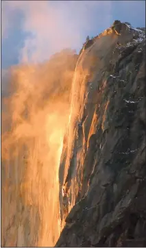  ?? ?? This stunning depiction of the natural firefall includes a cloud of mist that adds to the illusion of a fiery Horsetail Fall. Photo: Charles Phillips