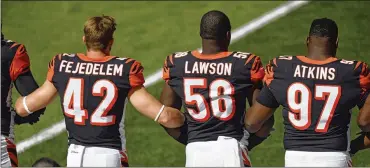  ?? DAVID RICHARD / ASSOCIATED PRESS ?? Bengals players lock arms during the national anthem before their game against the Browns on Sunday in Cleveland. “The thing is we have the utmost respect for our soldiers,” says cornerback Adam Jones.