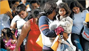  ?? ERIC GAY/AP ?? Immigrant families walk to a Texas respite center Wednesday after they were processed and released by border officials.