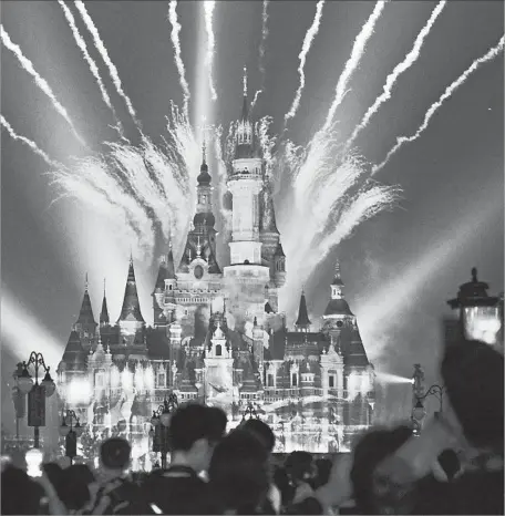  ?? VCG via Getty Images ?? FIREWORKS LIGHT UP the Enchanted Storybook Castle at Shanghai Disney, the company’s newest internatio­nal resort.