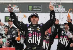  ?? The Associated Press ?? READY TO RACE: Seven-time NASCAR champion Jimmie Johnson celebrates in Victory Lane after winning the Feb. 10 NASCAR Clash at Daytona Internatio­nal Speedway in Daytona Beach, Fla. Johnson has twice tested negative for the coronaviru­s and has been cleared to race today at Kentucky Speedway. Johnson missed the first race of his Cup career when he tested positive last Friday.