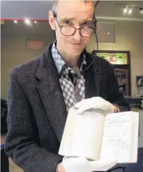  ??  ?? Local history . . . Waitaki District Archive curator of archives Chris Meech inspects a piece from the Perry family donation at the archives.