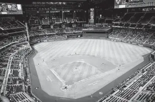  ?? Jonathan Zizzo / New York Times ?? The Rangers planned to allow 40,300 fans for an exhibition Monday against the Brewers at Globe Life Field, but only 12,911 people showed up for the game.