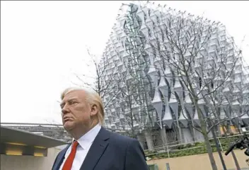 ?? Alastair Grant/Associated Press ?? The Madame Tussauds wax figure of President Donald Trump is seen on Friday outside the new U.S. Embassy in Nine Elms in London.