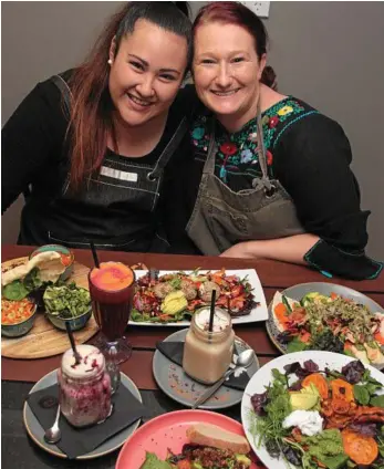  ??  ?? MEAT FREE: Homegrown Health chef Tash Ziebarth (left) and owner Kylie Pateman show off a range of dishes suitable for any busy person looking to go meat free, including nachos, burgers, raw vegie stacks, felafels and smoothies. PHOTO: MEGAN MASTERS
