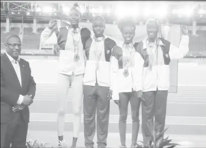  ??  ?? Chantoba Bright (extreme right) who helped the Girls U-20 4x400 relay team to a silver medal, will be back at the CARIFTA Games next year in the Cayman Islands for redemption in the triple jump.