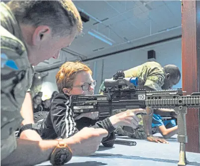  ?? Picture: Kim Cessford. ?? Kasey Simms from Forfar Academy tries out the DCCT electronic firing range.