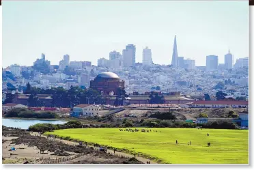  ?? ERIC RISBERG/ASSOCIATED PRESS ?? Top: Heavy smoke from wildfires bring a dark orange sky above Crissy Field and San Francisco on Sept. 9. Above: The same skyline behind Crissy Field is seen on a clear day. Wildfires that scorched huge swaths of the West Coast churned out massive plumes of choking smoke that blanketed millions of people with hazardous pollution that spiked emergency room visits and that experts say could continue generating health problems for years. An Associated Press analysis of air quality data shows 5.2 million people in five states were hit with hazardous levels of pollution for at least a day.