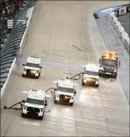  ?? Tim Nwachukwu / Getty Images ?? The NASCAR track drying team works to dry the track during a rain delay in the NASCAR Cup Series Drydene 400 on Sunday at Dover Motor Speedway in Dover, Del. Drying efforts were in vain, and the race was postponed until Monday.