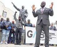  ?? ?? The Rev. Doyle Sprewer says a prayer at the foot of the Martin Luther King Jr. statue before the Youth Victory Over Violence Walk.