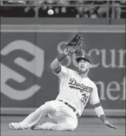  ?? Harry How Getty Images ?? CODY BELLINGER makes a catch in right field to rob Jarrod Dyson of a hit in the seventh inning.