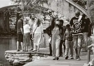  ?? Billy Calzada / Staff file photo ?? People visit the River Walk in late June, when Gov. Greg Abbott issued a directive ordering restaurant­s to scale back to 50 percent capacity, as well as the immediate closure of bars.