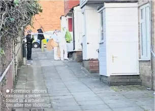  ??  ?? Forensics officers examine a jacket found in a wheelie bin after the shooting