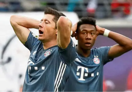  ?? — Reuters ?? We blew it!: Bayern Munich’s Robert Lewandowsk­i and David Alaba react after the Bundesliga match against Leipzig at the Red Bull Arena on Saturday.