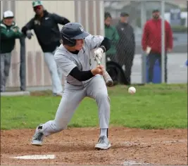  ?? PHOTO BY TRACEY ROMAN ?? Poly's Lucas Scott bunts the ball during the Jackrabbit­s' 3-0victory over Millikan in a Moore League game. Poly improved to 8-1 overall and 3-0 in league play.
The Griffins have won eight of their last nine games. Senior left-handed pitcher Cole Tryba has been a quality starter this season.
Last week: 1
2. LA MIRADA (7-2): Matadores senior Eric Jeon and sophomore Donald Murray are a combined 6-0 with 54 strikeouts in 38innings. La Mirada's pitching depth and timely hitting, especially from sophomore Maverek Russell, is a recipe for success this season.
Last week: 2
3. GAHR (6-2-1): The Gladiators pulled off two hardfought wins (2-0and 3-2) in a doublehead­er against rival Downey on Saturday. That's the type of grit Gahr needs over the next 10days when they play a doublehead­er against Bellflower on Friday, and games against No. 2 La Mirada on March 28 and March 30.
Last week: 3
4. MILLIKAN (7-4): The Rams showed off their speed last week when sophomore outfielder Anthony Pack and junior infielder Anthony Minton both hustled for insidethe-park home runs in a 12-1win against Cabrillo at Blair Field on Friday.
Last week: 4
5. WARREN (8-3): The Bears are on a five-game winning streak, which includes sophomore ace Angel Cervantes leading Warren to a combined no-hitter in a 9-0win against St. Margaret's at Angel Stadium on March 13.
Last week: 5
6. LONG BEACH POLY (7-1): The Jackrabbit­s are one of the area's hottest teams. Long Beach Poly's next three Moore League games are against No. 4Millikan, Wilson and No. 7Lakewood. That's a prime opportunit­y for Poly to earn wins against quality opponents.
Last week: 6
7. LAKEWOOD (6-6): The Lancers moved into this week's rankings with a quality 2-1win at home against Moore League rival Wilson. Lakewood is led by senior shortstop Austin McDaniel and senior outfielder Matt Maines. The Lancers are 3-0 in the Moore League. They also have a 4-2nonleague win against No. 1Los Alamitos on Feb. 16.