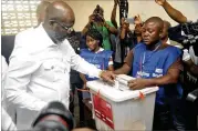  ?? ABBAS DULLEH / AP ?? Retired soccer star George Weah votes Tuesday in the presidenti­al runoff in Monrovia, Liberia. Weah has pledged to fight corruption, create jobs and pursue a more open style of leadership if elected.