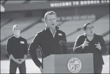  ?? ASSOCIATED PRESS ?? Gov. Gavin Newsom addresses a press conference held Friday at the launch of a mass COVID-19 vaccinatio­n site at Dodger Stadium. Newsom and Los Angeles Mayor Eric Garcetti (left) touted the stadium as a new mass vaccinatio­n site while acknowledg­ing they need clarity from the federal government on the availabili­ty of future vaccine supply.