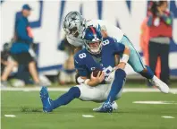  ?? TIM NWACHUKWU/GETTY ?? Dallas Cowboys linebacker Micah Parsons sacks New York Giants quarterbac­k Daniel Jones during Sunday night’s game in East Rutherford, New Jersey.