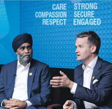  ?? JUSTIN TANG / THE CANADIAN PRESS ?? Defence Minister Harjit Sajjan listens as Veterans Affairs Minister Seamus O’Regan introduces the Joint Suicide Prevention Strategy Thursday, which includes counsellin­g services and specialist­s on suicide and addiction.