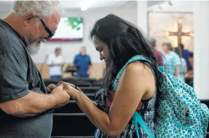  ?? Photos by Lisa Krantz / Staff photograph­er ?? After a June 17 service at First Baptist Church in Sutherland Springs, the first she attended since the massacre there in November, Danielle Kelley cries as she prays with Stephen Willeford, who shot her husband, Devin Kelley, after the slayings he committed.