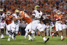  ?? RICHARD SHIRO - THE ASSOCIATED PRESS ?? Boston College’s AJ Dillon, center, runs in for a touchdown during the first half of an NCAA college football game against Clemson, Saturday, Oct. 26, 2019, in Clemson, S.C.