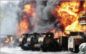  ?? THE ASSOCIATED PRESS ?? Vehicles are on fire at an oil depot after missiles struck the facility in an area controlled by Russian-backed separatist forces in Makiivka, eastern Ukraine, on Wednesday.