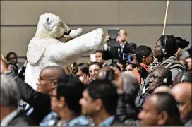  ?? MARTIN MEISSNER / ASSOCIATED PRESS ?? A man in a polar bear costume walks between delegates Monday during the opening of the U.N. climate change conference in Bonn, Germany. The two-week meeting is the first major conference on climate change since President Donald Trump announced the...