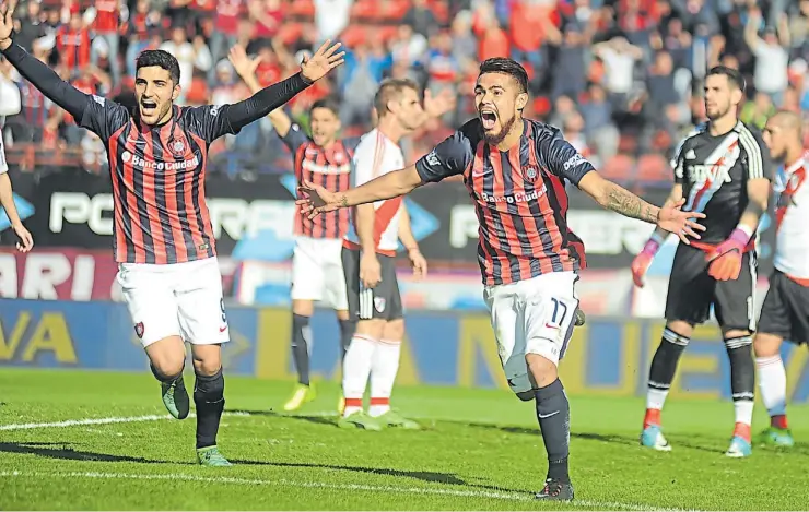  ?? FEDERICO LOPEZ CLARO ?? Goleadores. Nicolás Blandi convirtió el primero con una gran volea y Paulo Díaz definió el partido tras la falla de Augusto Batalla. San Lorenzo sigue prendido arriba.