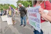  ?? H John Voorhees III/Hearst Connecticu­t Media file photos ?? Newtown Democrats held a rally against the Board of Education’s possible vote to ban two books, “Flamer” by Mike Curato and “Blankets” by Craig Thompson, from the high school’s library.